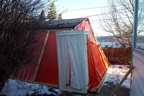 Typical containment setup for asbestos containing stucco on a residential garage