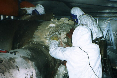 Abatement crew removing asbestos from steam header