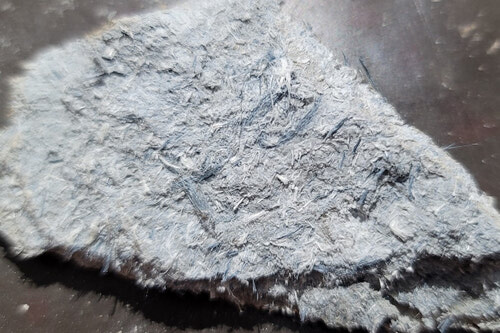 Chrysotile and Crocidolite (blue) asbestos in cement piping